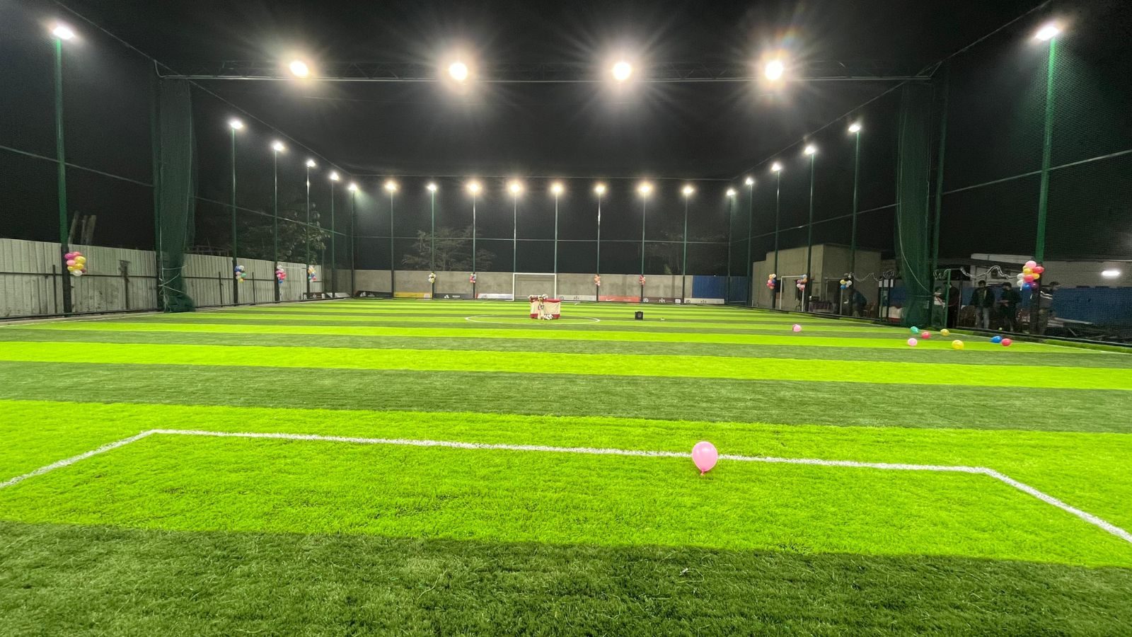 The SpotTurf pitch lit up by floodlights at night